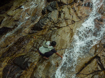 Rear view of man on rock