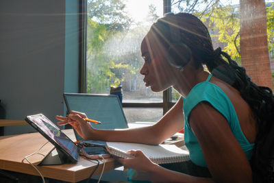 Young woman using laptop at home