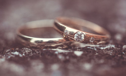 Close-up of wedding rings on table