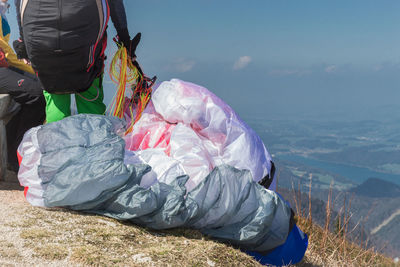 People on mountain preparing for paragliding