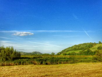 Scenic view of field against cloudy sky