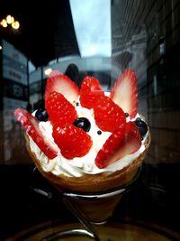 Close-up of strawberry and ice cream