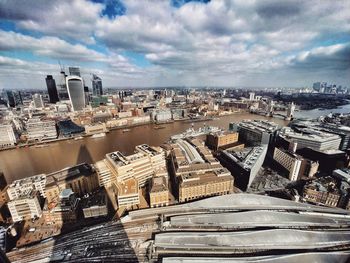 High angle view of buildings against cloudy sky