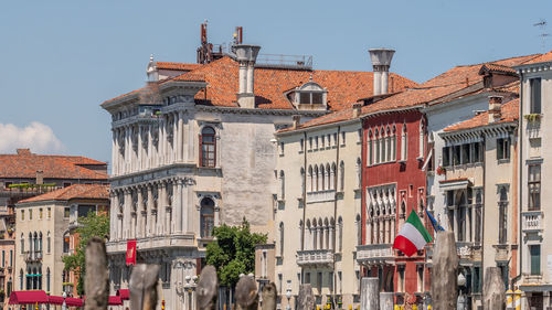 Buildings in city against clear sky