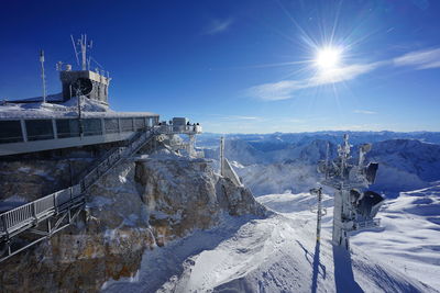 Panoramic view of snow covered landscape against sky