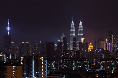 High angle view of city lit up at night