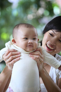 Portrait of mother carrying baby boy