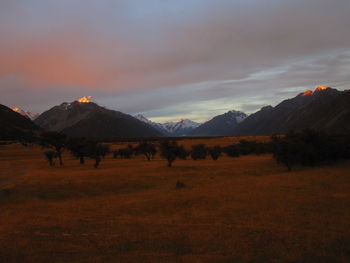Scenic view of field against sky during sunset