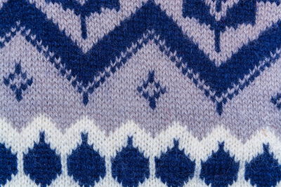 Texture of wool with white, gray, blue geometric patterns