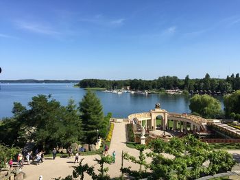 Tourist visiting formal garden by river