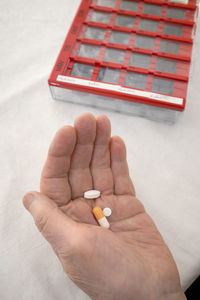 Close-up of person taking various medications