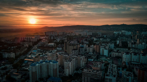 High angle view of illuminated buildings against sky during sunset