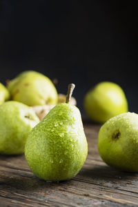 Close-up of apple on table against black background