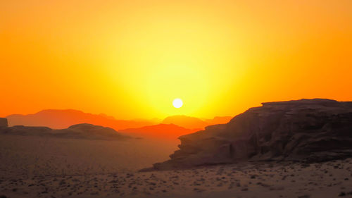 Scenic view of sea against orange sky