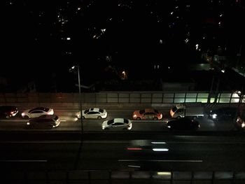 Cars on city street at night