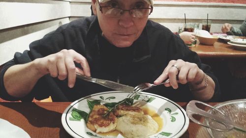 Midsection of man having food in restaurant