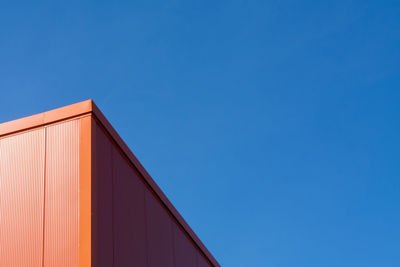 Low angle view of building against clear blue sky