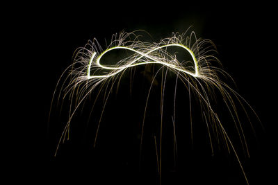 Low angle view of firework display against sky at night