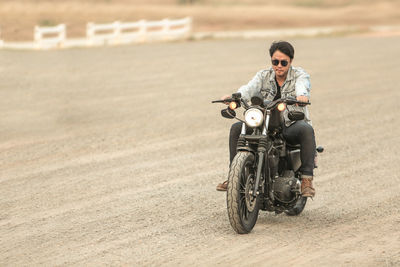 Man riding motorcycle on road