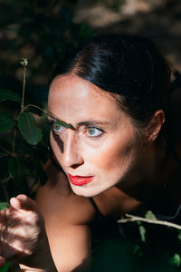 Close-up of woman holding leaf outdoors