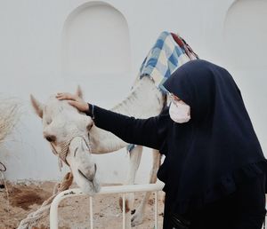 Rear view of man with horse