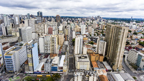 Aerial view of city against cloudy sky