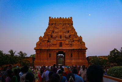 Group of people in temple against clear sky