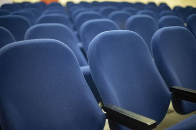 Seats are blue. interior details. chairs in cinema. room for watching movies.