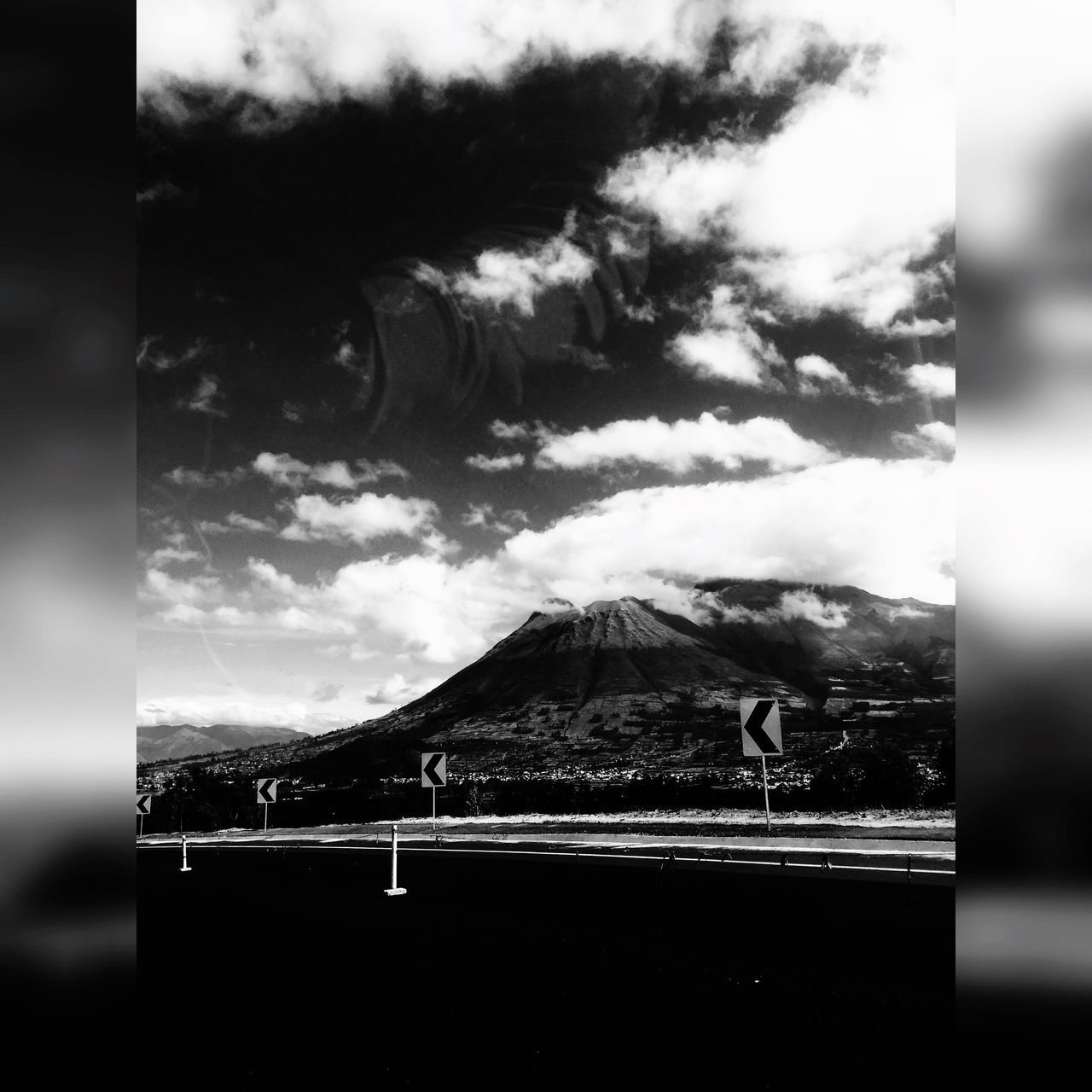 sky, mountain, text, western script, cloud - sky, communication, landscape, focus on foreground, cloud, transportation, metal, fence, cloudy, no people, day, railing, outdoors, close-up, nature, selective focus