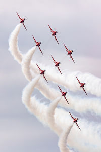 Low angle view of airshow against sky