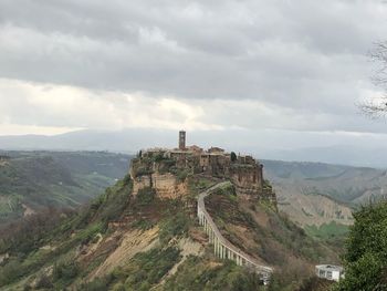 Castle on mountain against sky