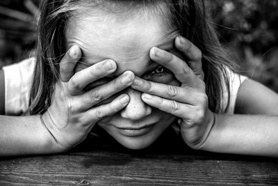 Close-up portrait of woman with hands