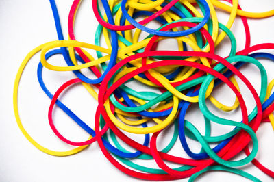 Close-up of colorful rubber bands over white background