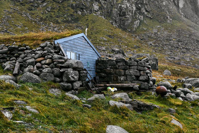 Blue wooden fishing cabin stokkvika at the beach in moskenesoya lofoten islands in norway.