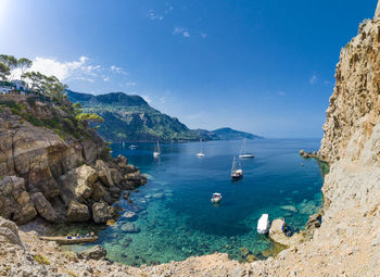 Scenic view of sea and mountains against sky