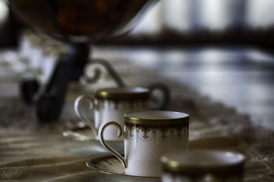 Close-up of tea cups on table