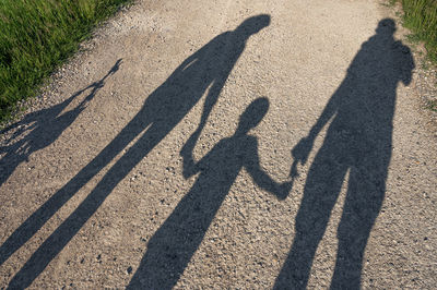 Shadow of people on road