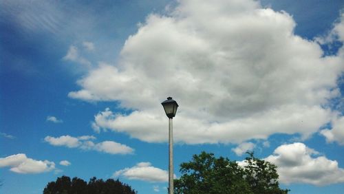 Low angle view of street light against cloudy sky