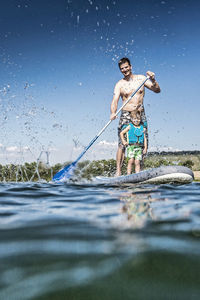 Full length of man standing in water