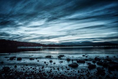 Scenic view of lake against sky during winter