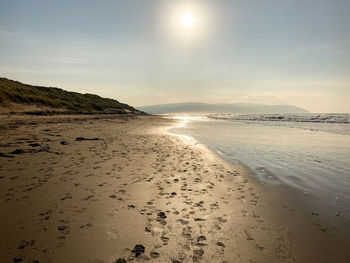 Scenic view of beach against sky during sunset