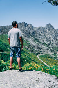 Rear view of man looking at mountains