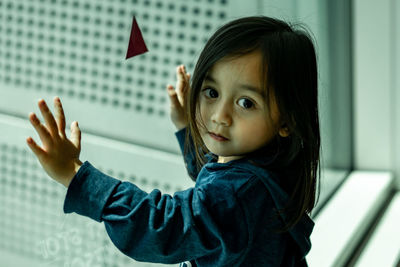 Portrait of cute girl near glass window.