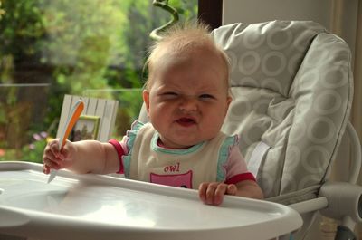 Portrait of smiling baby girl in chair