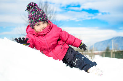 Midsection of child in snow against sky