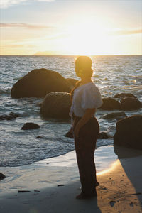 Rear view of man looking at sea shore