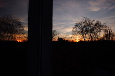 Silhouette trees against sky during sunset