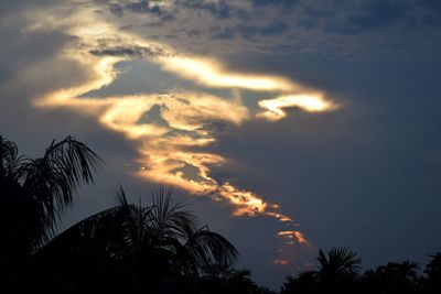 Low angle view of silhouette palm trees against romantic sky