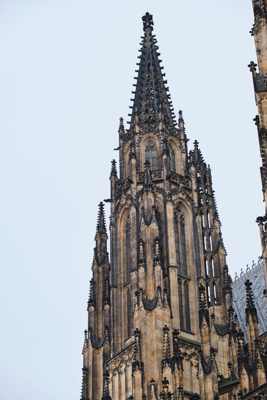 architecture, built structure, building exterior, travel destinations, spire, building, religion, place of worship, history, tower, the past, belief, travel, sky, low angle view, tourism, spirituality, city, worship, nature, landmark, no people, clear sky, day, outdoors, gothic style, catholicism, temple, facade