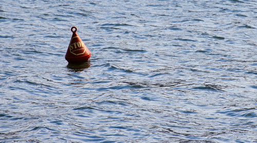 Buoy floating on lake